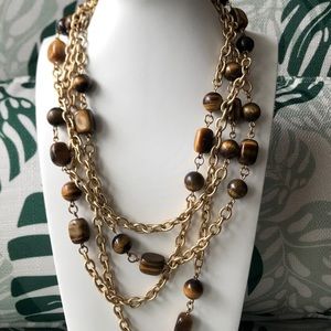 35”-42” long vintage genuine tigers eye necklace with gold tone links.